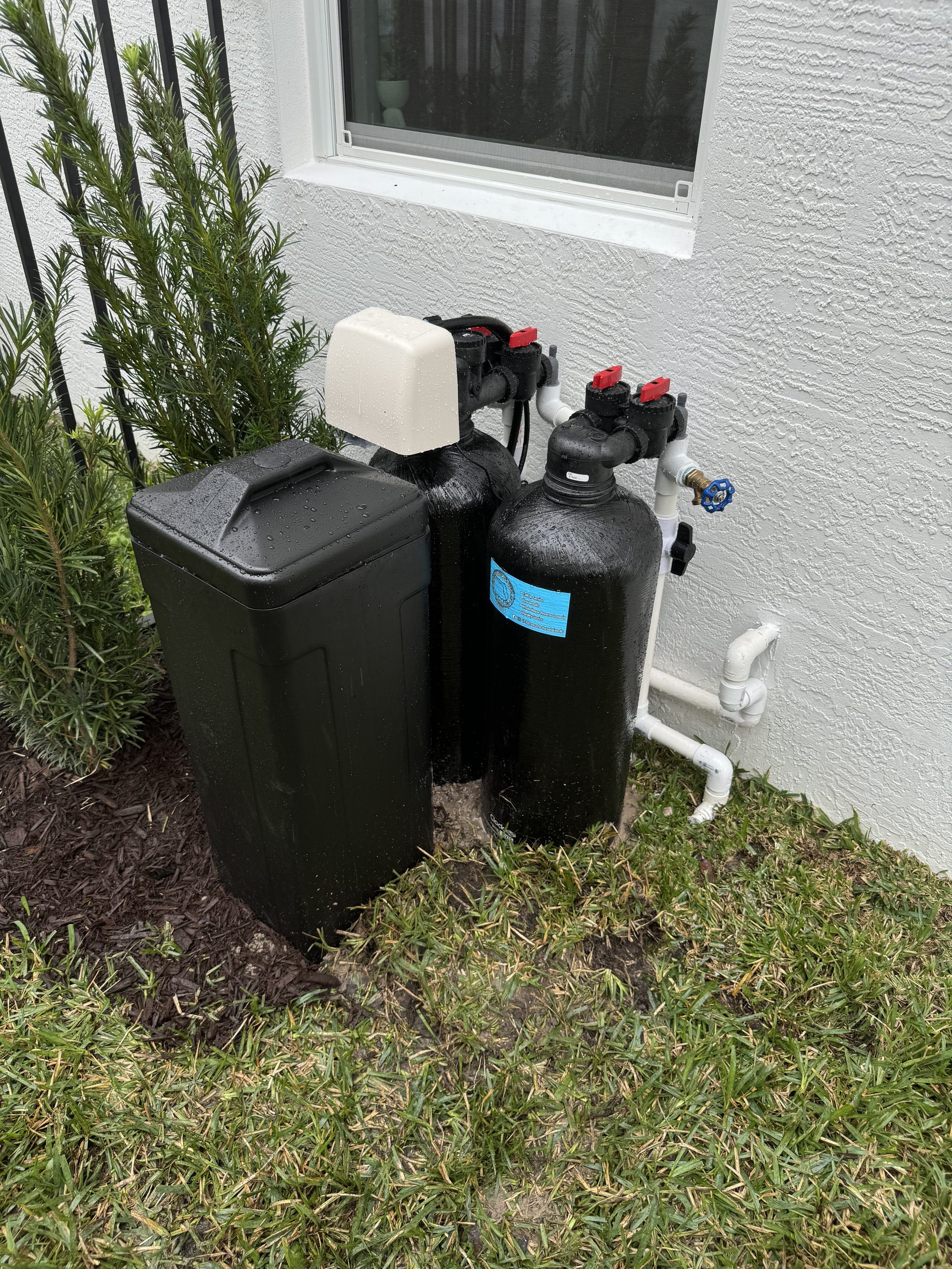 Carbon water filtration system installed outdoors in South Florida by Advanced Water Solutions