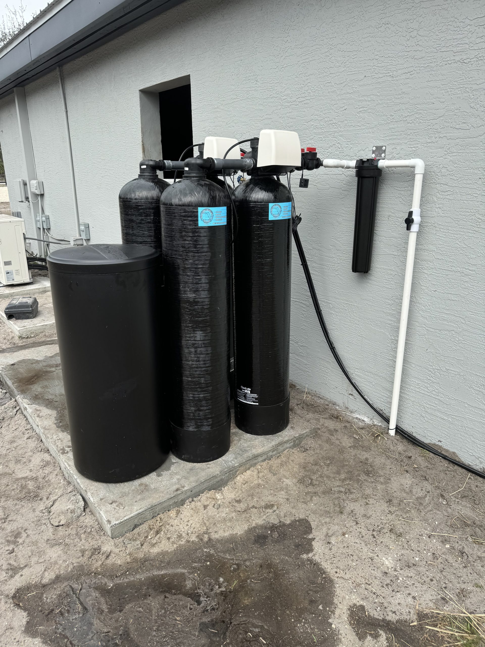 Whole-home water filtration system with multiple tanks installed by Advanced Water Solutions in Jupiter, FL